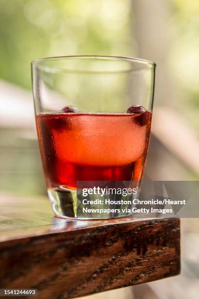 The Rainbow Lodge's Cabin Fever cocktail, house pecan infused Texas bourbon, cranberry juice with citrus cube, water frozen cranberries,...