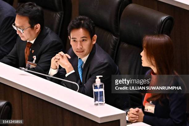 Move Forward Party leader and prime minister candidate Pita Limjaroenrat sits inside the Thai Parliament with fellow party members as deliberations...