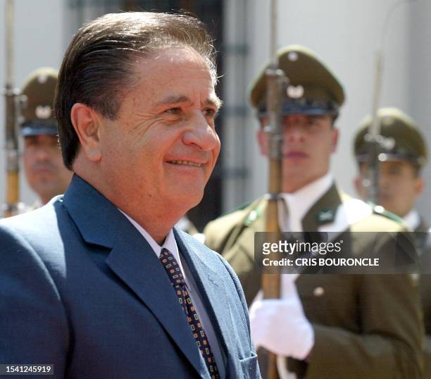 Argentinean President Eduardo Duhalde walks past soldiers at a ceremony for the signing of treaties of mutual cooperation between both countries, at...
