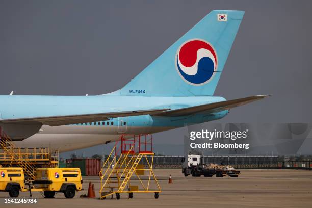 The tail of a Boeing Co. 747-8I passenger aircraft, operated by Korean Air Lines Co., on the tarmac outside the company's hangar at Incheon...