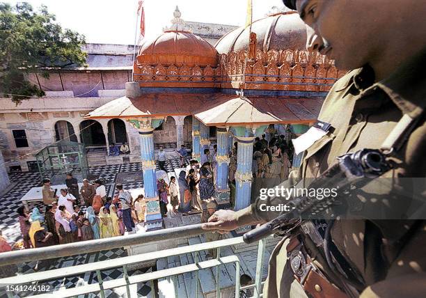 Policeman stands guard while tourists visit the Brahma temple in Pushkar 17 November 2002, in Rajasthan state. The US and Britian warned its citizens...