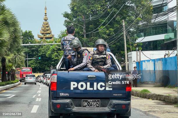 Police patrol on a street in Yangon on July 19 on the 76th Martyrs' Day, which marks the anniversary of the assassination of independence leaders...