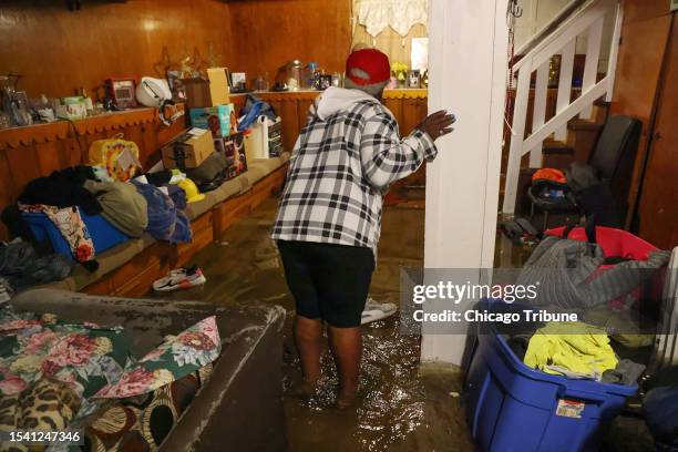 Shirley Howard stands in her flooded basement in Chicago's Austin neighborhood on July 2, 2023.