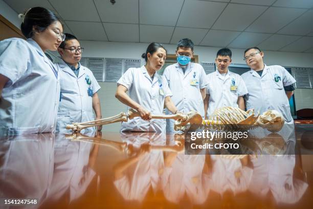 Medical staff discuss the treatment of femoral head necrosis at the First People's Hospital in Bijie, Southwest China's Guizhou province, July 13,...