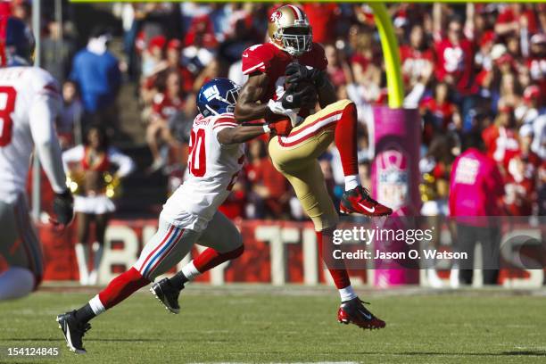 Wide receiver Randy Moss of the San Francisco 49ers catches a pass in front of cornerback Prince Amukamara of the New York Giants during the third...