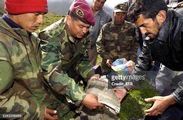 Ecuadoran Col. Juan Carlos Vergara demonstrates a newspaper 18 February reportedly recovered from the site of a 27 year-old plane crash. The wreckage...