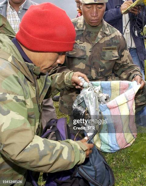 Soldier inspects a bag 18 February reportedly recovered from the site of a 27 year-old plane crash. The wreckage of the Saeta Airlines airplane lost...