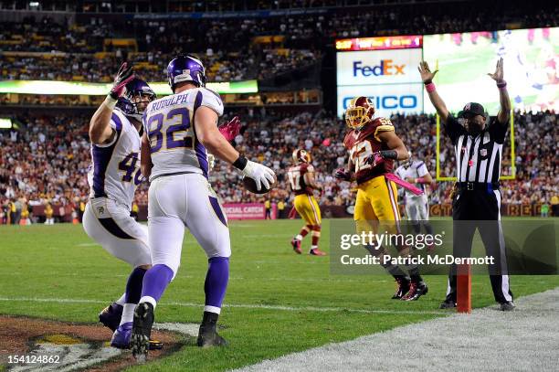 Kyle Rudolph celebrates with Rhett Ellison of the Minnesota Vikings after scoring a 1-yard touchdown on a pass from Christian Ponder in the second...