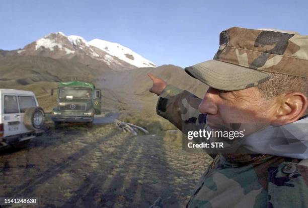 Soldier points to the foot of Mount Chimborazo, 130kms south of Quito 18 February, 2003 the site of a 27 year-old plane crash. The wreckage of the...