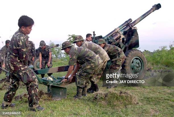 Philippine army soldiers position artillery fire on the second day of an assault on areas held by Muslim separatist Moro Islamic Liberation Front...