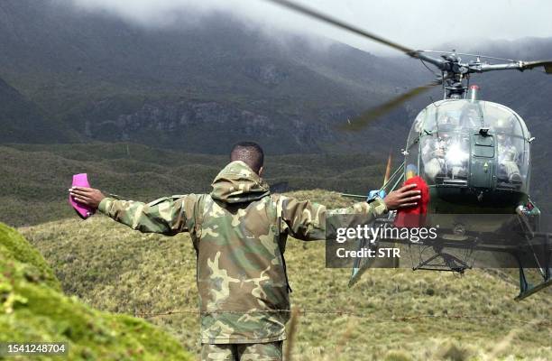 Helicopter lands south of Quito, Ecuador 18 February, 2003 at the site of a 27 year-old plane crash. The wreckage of the Saeta Airlines airplane lost...