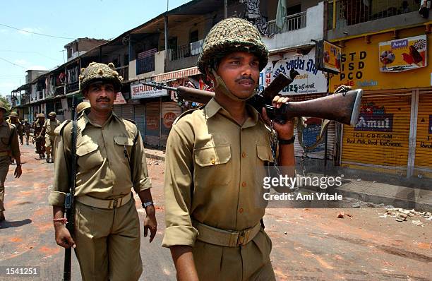 Indian police patrol the streets in an attempt to stop communal violence May 10, 2002 in Ahmedabad, India. Violence erupted in the state of Gujarat...