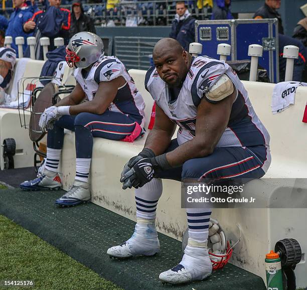 Defensive tackle Vince Wilfork and defensive end Justin Francis of the New England Patriots sit on the bench near the end of the game against the...