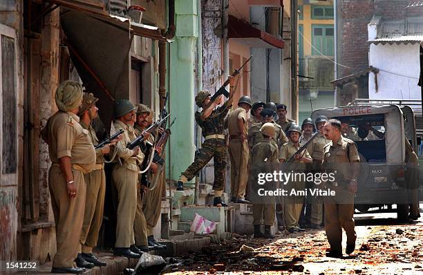 Indian police patrol the streets in an attempt to stop communal violence May 10, 2002 in Ahmedabad, India. Violence erupted in the state of Gujarat...