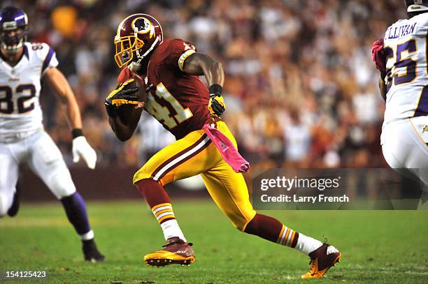 Madieu Williams of the Washington Redskins intercepts a pass and returns it for a touchdown against the Minnesota Vikings at FedExField on October...