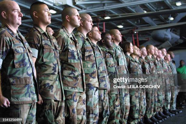 Marines of the VMFA-323 squadron named "Death Rattlers" prepare to shout out a holiday greeting to US citizens in front of a television camera aboard...