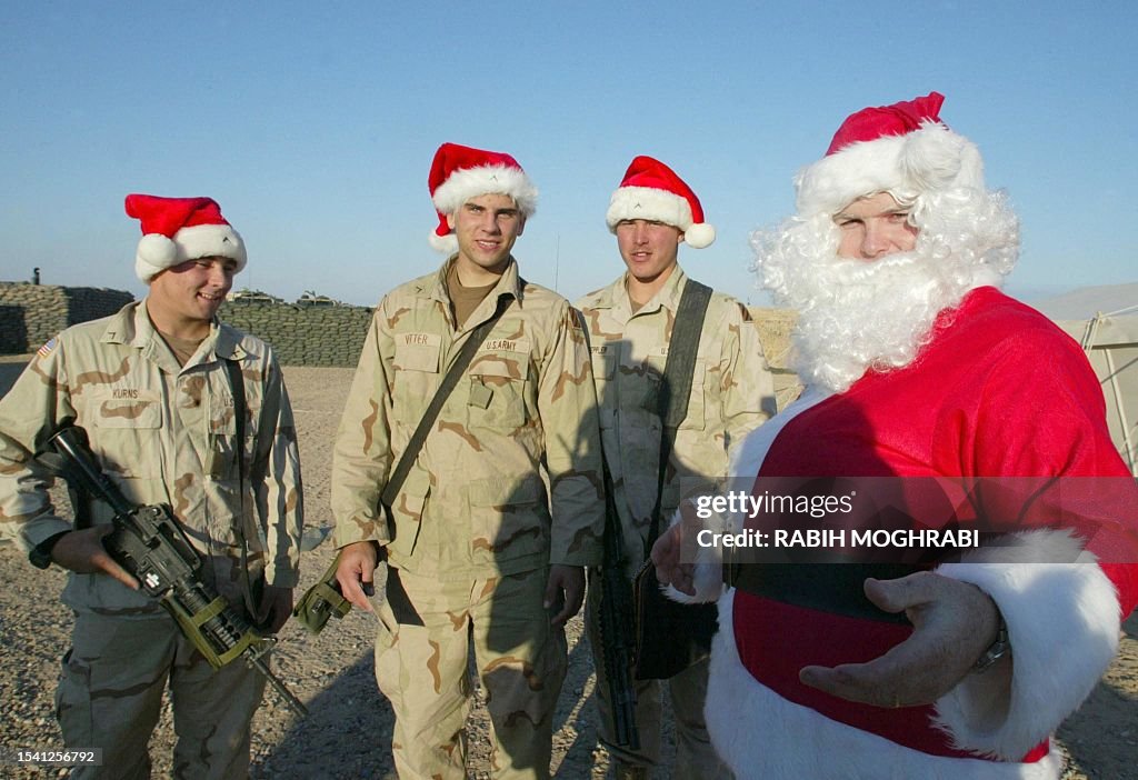 Kuwait Santa US soldiers pose next to a Santa Claus on Christmas day at Camp... News ...