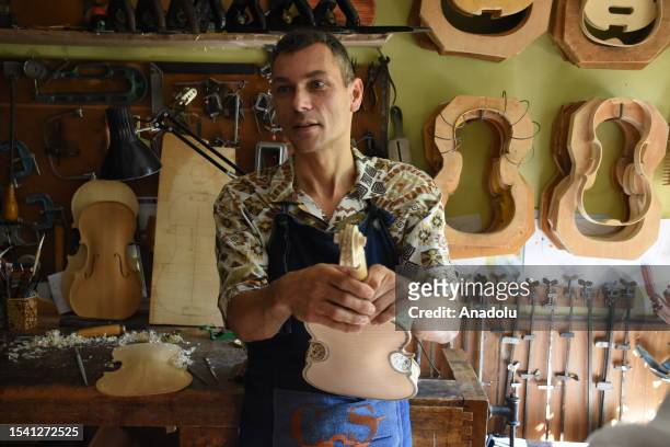 Italian luthier Stefano Conia gives an exclusive interview as he makes a violin in Cremona, Italy on July 4, 2023. The city of Cremona is a brand in...
