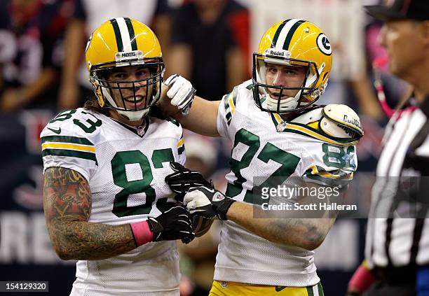 Jordy Nelson of the Green Bay Packers celebrates with teammate Tom Crabtree after Nelson's third touchdown of the game in the third quarter against...