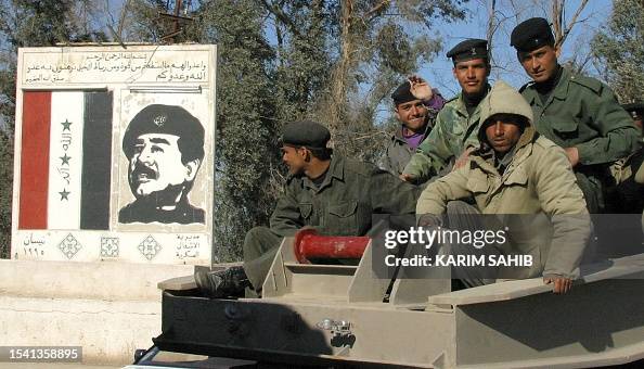 Samoud Iraqi soldiers sit ontop of a truk, carrying Al-Samoud 2 missiles as ...