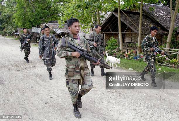 Troops patrol the deserted town streets of Pikit as part of a military offensive to capture an enclave of the Muslim separatist Moro Islamic...