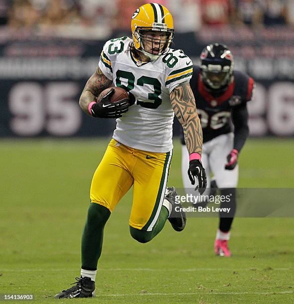 Tom Crabtree of the Green Bay Packers completes a catch and runs for a 48 yard touchdown against the Houston Texans at Reliant Stadium on October 14,...
