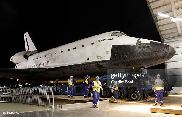 The Space Shuttle Endeavour is moved into the hangar in the California Science Center on October 14, 2012 in Los Angeles, California. Endeavour is on...