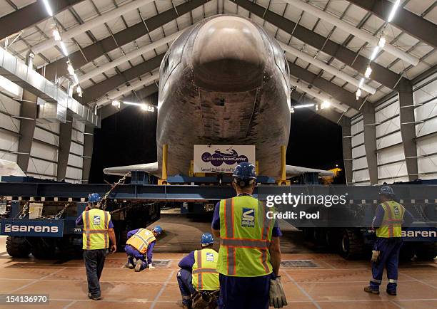 The crew carefully guide the Space Shuttle Endeavour into it's new home at the hangar in the California Science Center on October 14, 2012 in Los...