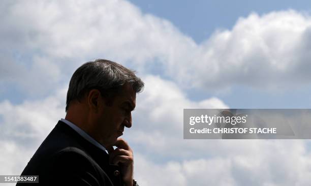 The silhouette of Bavaria's State Prime Minister Markus Soeder is seen prior to the summer retreat of the Christian Social Union party at the Andechs...