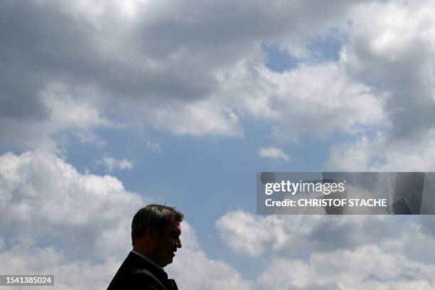 The silhouette of Bavaria's State Prime Minister Markus Soeder is seen prior to the summer retreat of the Christian Social Union party at the Andechs...