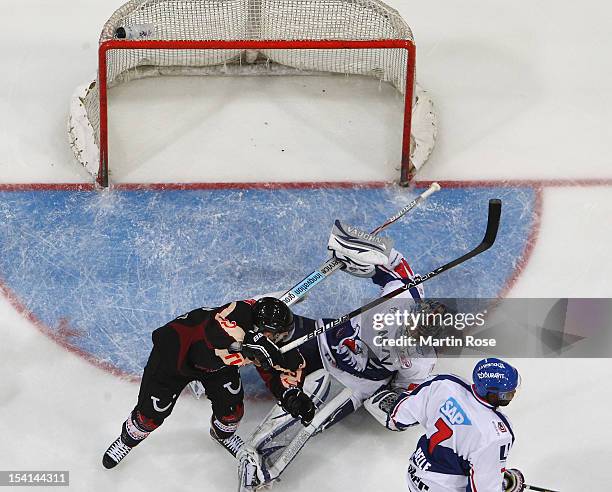 Dennis Endras , goaltender of Mannheim save the shot of Andreas Morczinietz of Hannover during the DEL match between Hannover Scorpions and Aadler...