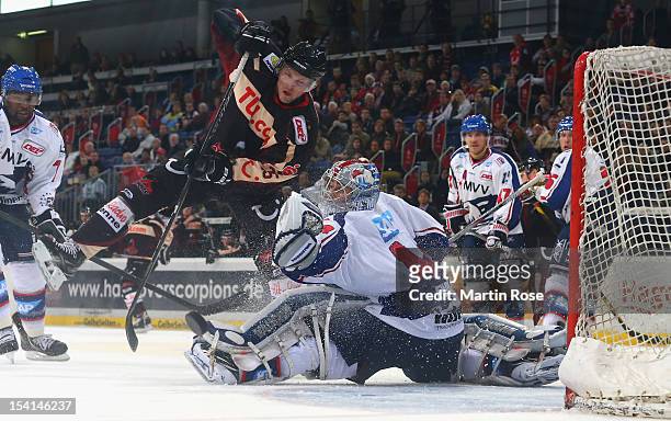 Dennis Endras , goaltender of Mannheim save the shot of Andreas Morczinietz of Hannover during the DEL match between Hannover Scorpions and Adler...