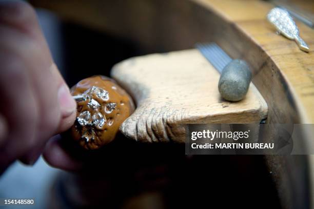 Jeweler works on a piece of the French Van Cleef & Arpels jewellery on January 14, 2010 in the workshop of the company in Paris.The company was...