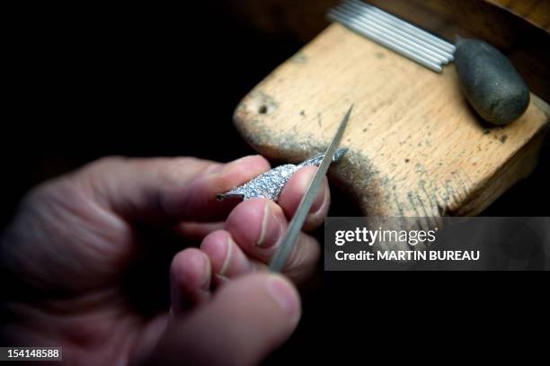 Jeweler works on a piece of the French Van Cleef & Arpels jewellery on January 14, 2010 in the workshop of the company in Paris.The company was...