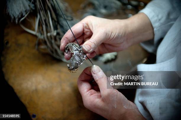 Jeweler works on a piece of the French Van Cleef & Arpels jewellery on January 14, 2010 in the workshop of the company in Paris.The company was...