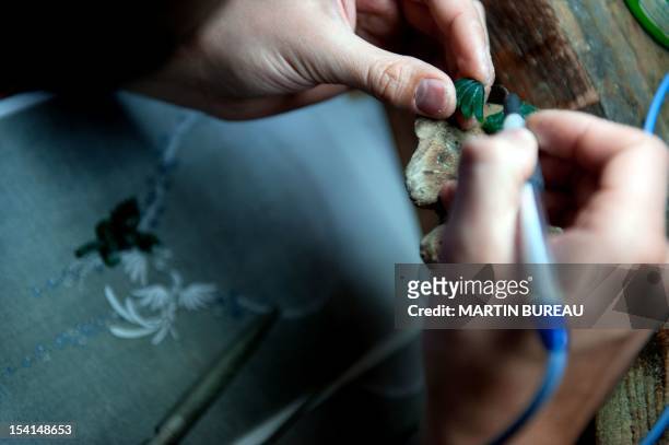 Jeweler works on a piece of the French Van Cleef & Arpels jewellery on January 14, 2010 in the workshop of the company in Paris.The company was...