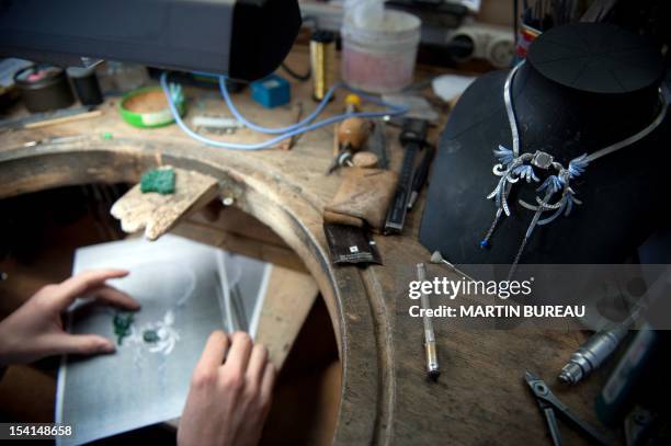 Jeweler works on a piece of the French Van Cleef & Arpels jewellery on January 14, 2010 in the workshop of the company in Paris.The company was...