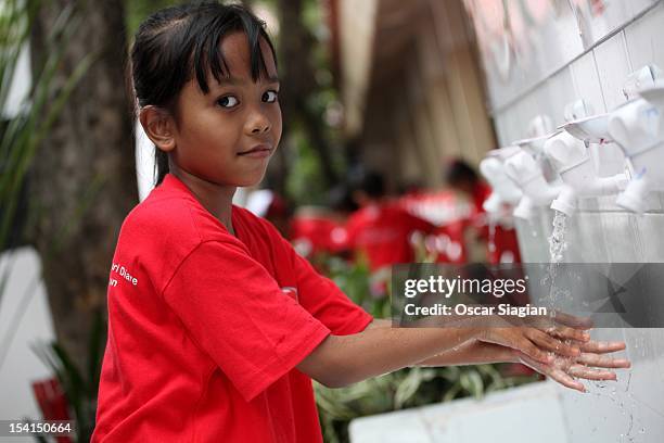 Child washes her hands with soap to celebrate Global Handwashing Day on October 15, 2012 in Jakarta, Indonesia. Celebrated in over 100 countries,...
