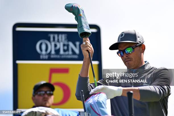 Golfer Rickie Fowler takes a club from his bag on the 5th tee during a practice round for 151st British Open Golf Championship at Royal Liverpool...