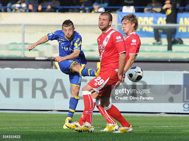 Alessandro Carrozza of Hellas Verona competes with Emanuele Padella and Vedran Celjak of Grosseto during the Serie B match between Hellas Verona FC...