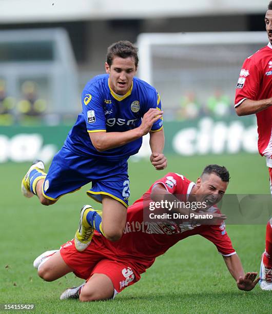 Juanito Gomez Taleb of Hellas Verona is tackled by Michele Rigione of Grosseto during the Serie B match between Hellas Verona FC and US Grosseto at...