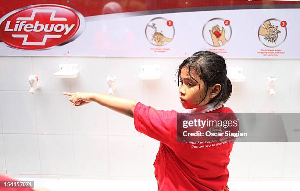 Young girl prepares to wash her hands with soap as part of Global Handwashing Day on October 15, 2012 in Jakarta, Indonesia. Celebrated in over 100...