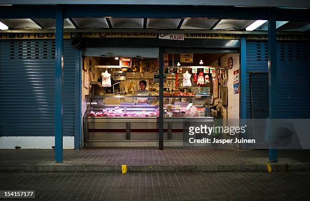 Woman stands inside a butcher shop at the old market, where only a few stalls remain open, on October 11, 2012 in the small industrial town of...
