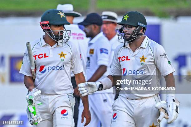 Pakistan's captain Babar Azam and Imam-ul-Haq walk back to the pavilion at the end of the fourth day of the first cricket Test match between Sri...