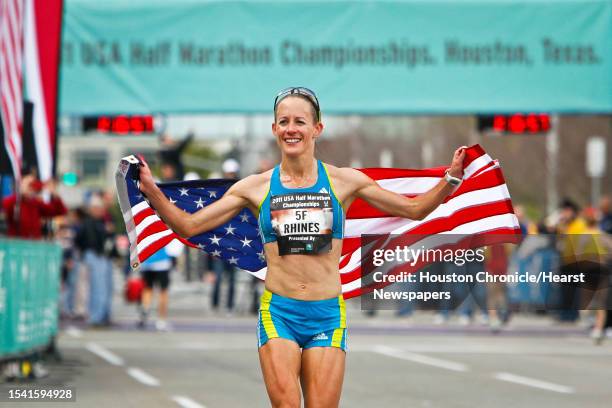 Jen Rhines carries an American Flag after winning the Women's 2011 USA Half Marathon National Championships Saturday, Jan. 29 in Houston.