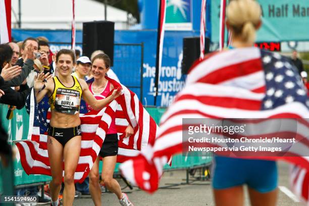 Serena Burla, 2nd place, and Nan Kennard, 3rd place, get congratulated by fans as Jen Rhines, 1st place, looks on during the Women's 2011 USA Half...