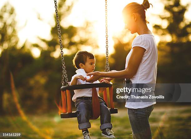 woman with her kid - mother and son at playground stock-fotos und bilder