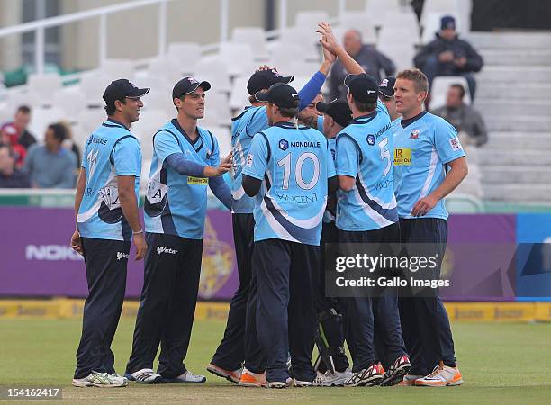 Auckland Aces team-mates celebrate during the Karbonn Smart CLT20 match between Kolkata Knight Riders and Auckland Aces at Sahara Park Newlands on...