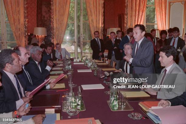 Prime Minister Michel Rocard , with his chief of staff Jean-Paul Huchon at his side, addresses Jean-Marie Tjibaou , Kanak independence leader and...