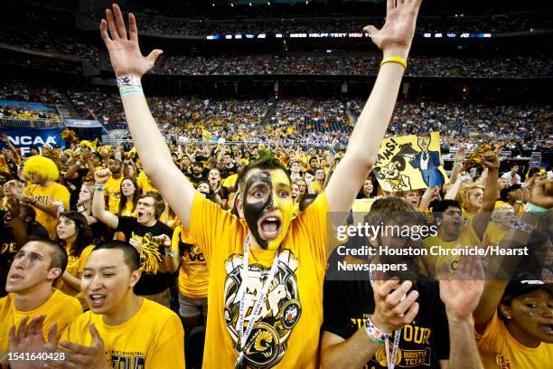 Fan, Jara Janulis, raises his hands along with other fans during the first half of the Butler vs VCU Semifinals matchup during the NCAA Final Four at...